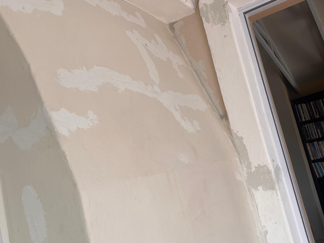 Wall skim coat and surface prep — door frame detail